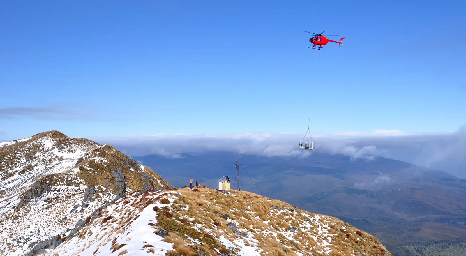 Helicopter long-lining equipment to an exploration site at Mount Glasgow, North Buller